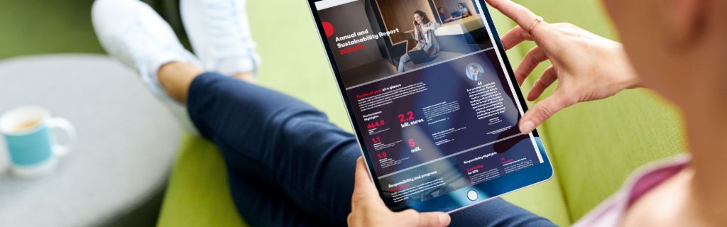 EOS ASR: A imagem mostra uma jovem mulher a segurar um tablet e a consultar nele o Relatório Anual de Sustentabilidade da EOS.