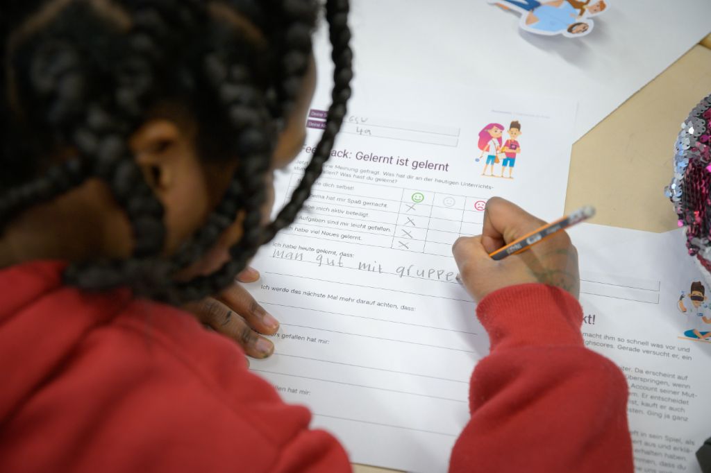 Financial education for children: Child completes a feedback form on the finlit initiative.